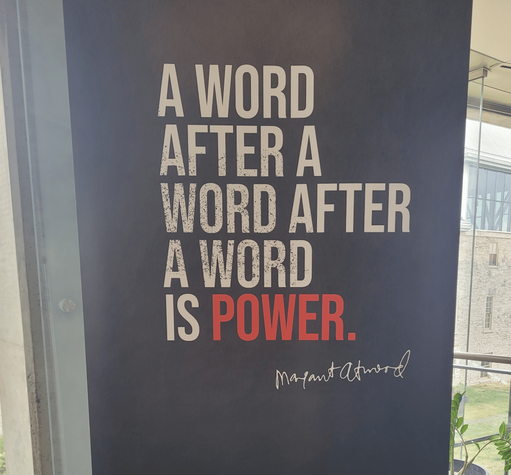 A sign says: "A word after a word after a word is power." Margaret Atwood