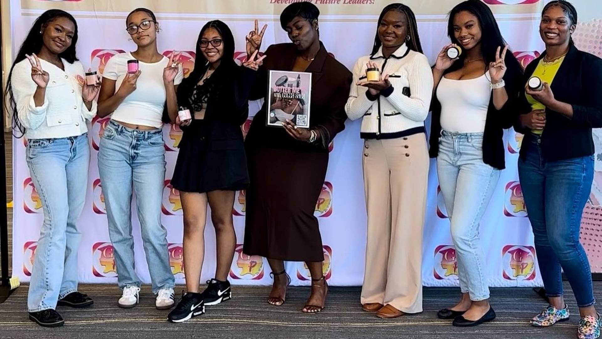 a group of 7 young women posing for the camera in from tof a Girls PREP banner. 