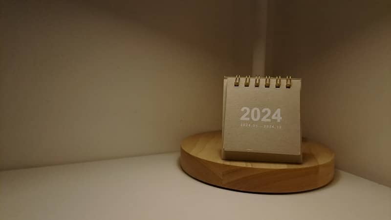 A desk lamp with a calendar on top of it