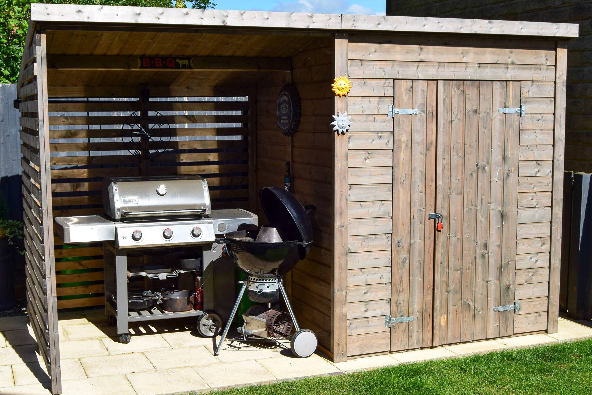 BBQ shack and 2 barbecues, one is a weber gas and one is a weber charcoal