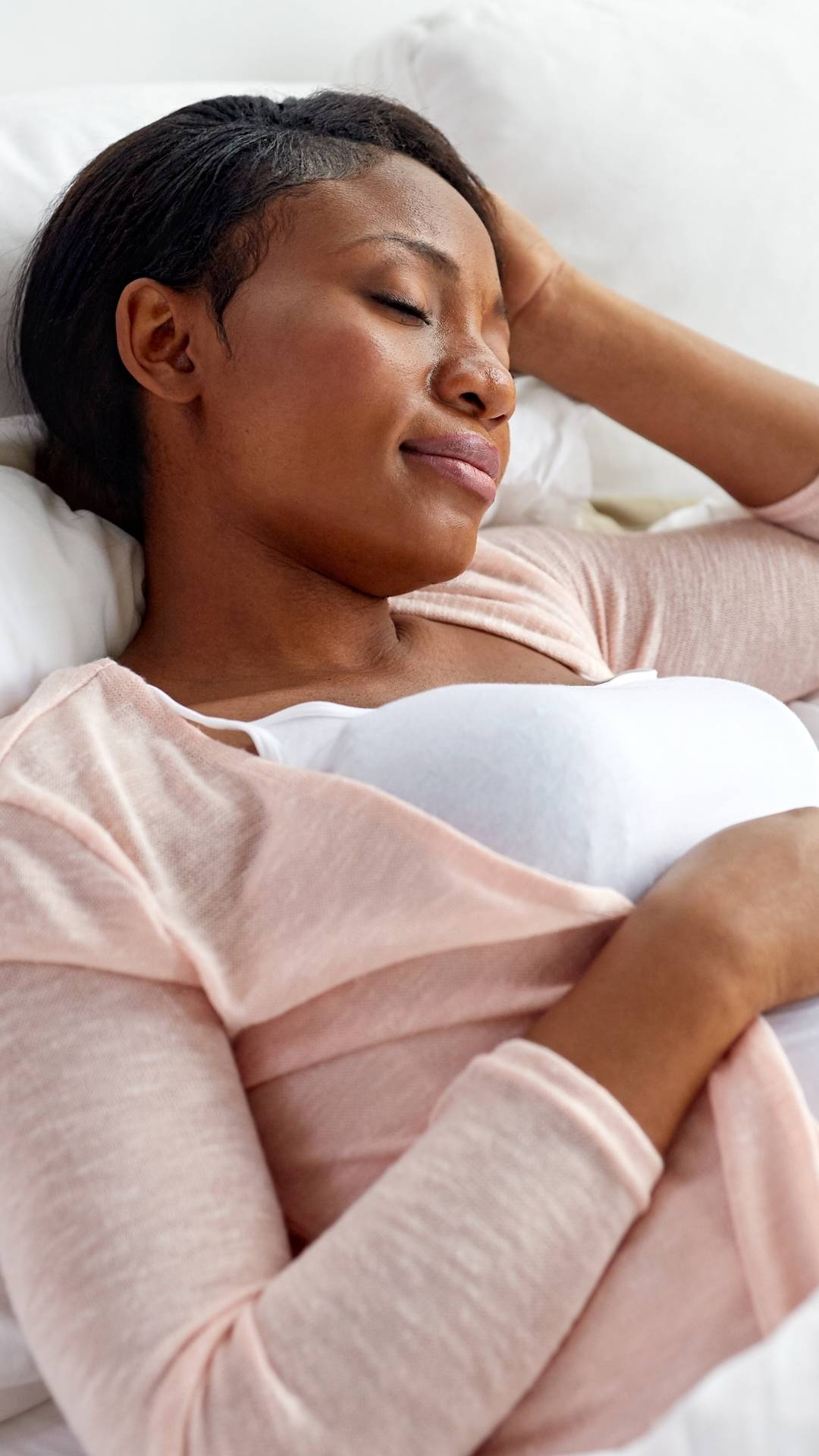 woman in white dress shirt sitting on brown grass field during daytime