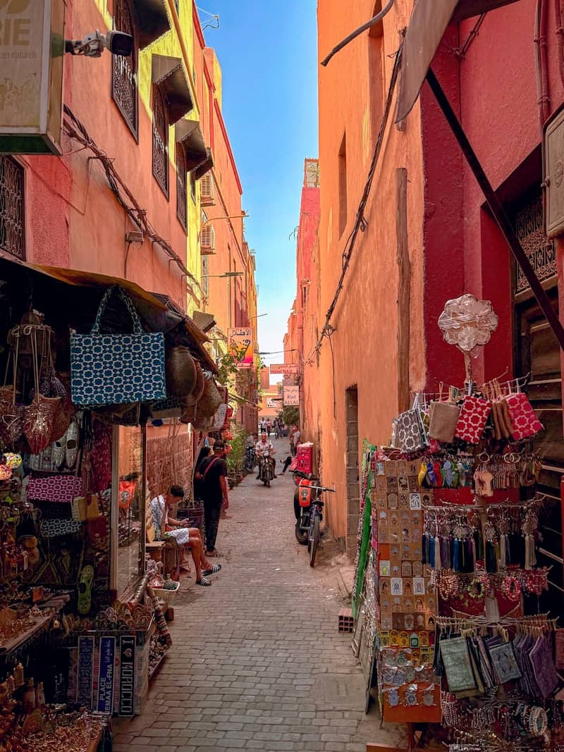 Narrow street lined with shops and people