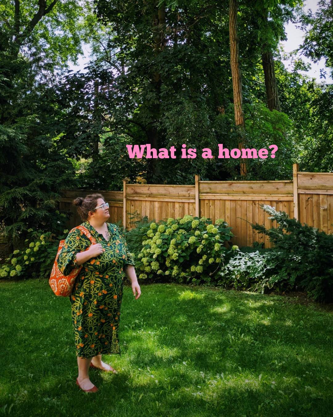 A figure stands in a backyard full of greenery, the text 'what is a home' floats in pink above them.