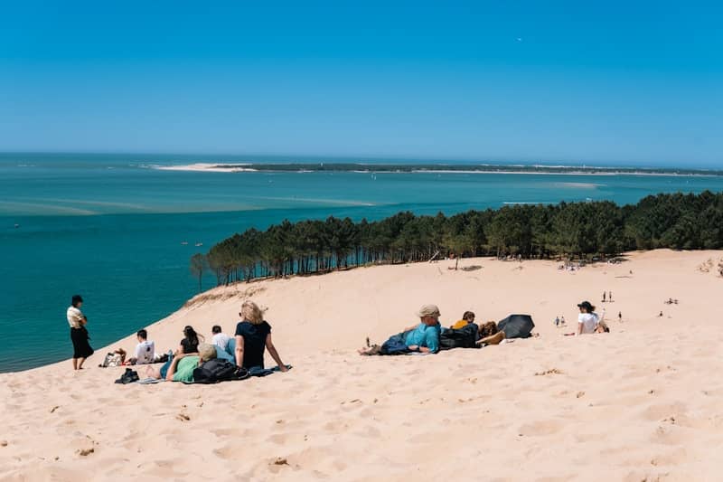 People enjoy the beach on a sunny day.