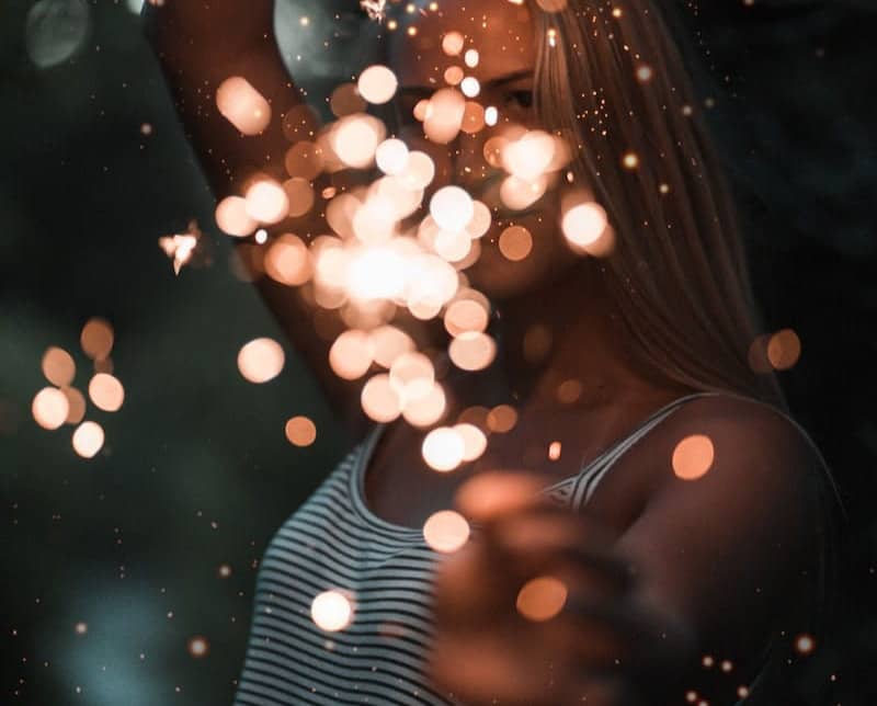 woman holding sparklers bokeh photography