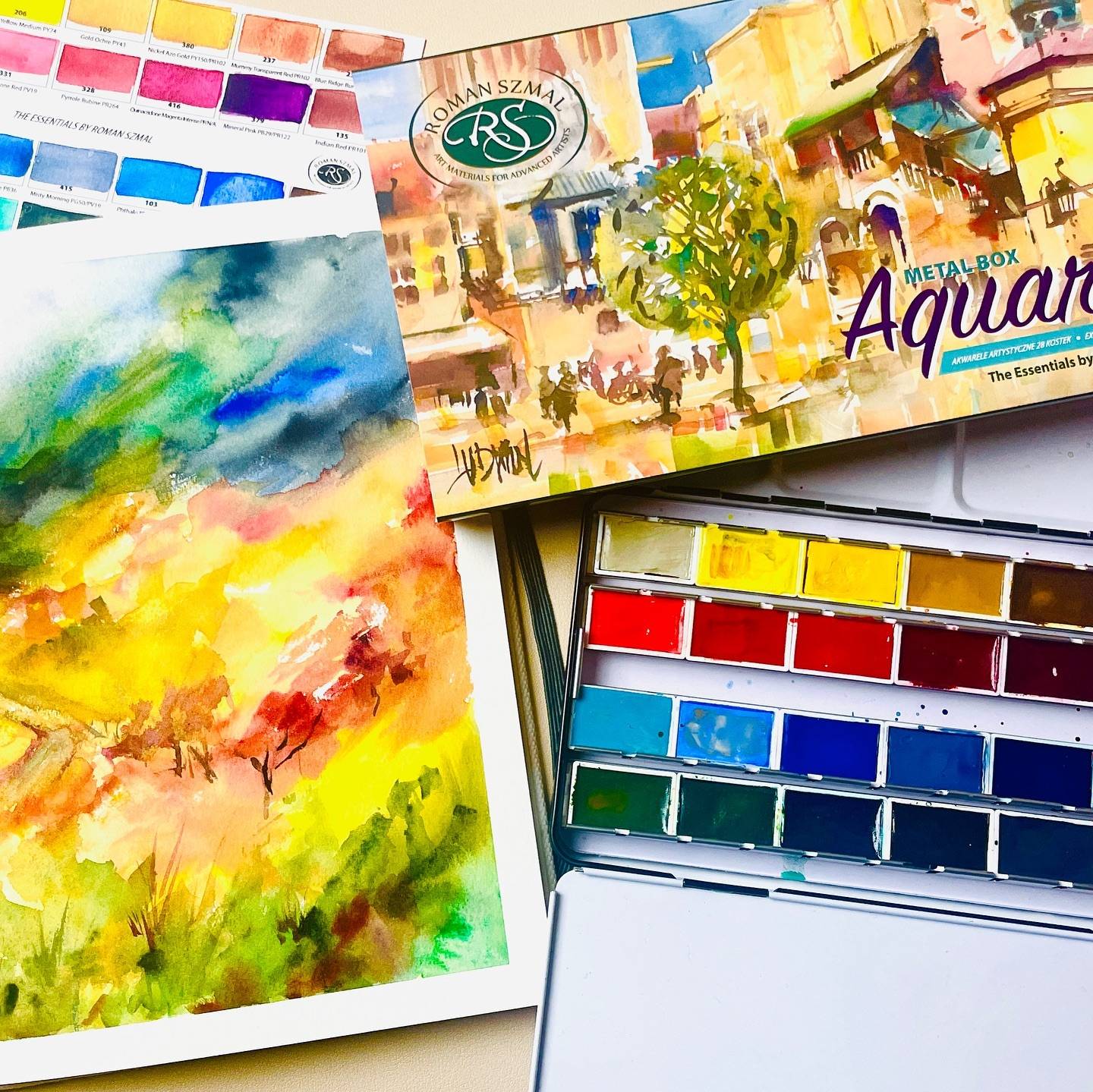 Giveaway for my members : Roman Szmal’s Essential 28 Full pan palette 😍 details in my YouTube video. 
Truly one of my favourite palettes thus far. 

What are you enjoying using? 

I’m enjoying the process of experimenting with watercolour landscapes 😍 and included all the colours, even if in a small way in this landscape painting. ( without creating mud 🤩😂) 

📙 @etchr_lab 
📖 for swatching : @st_cuthberts_mill @st.cuthberts.mill 
🎨 @roman_szmal_art 

Special thank you to @roman_szmal_art for the gift! 
#watercolor #watercolorart