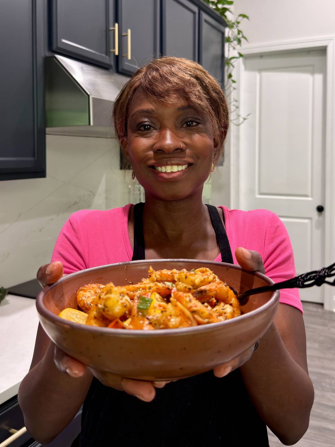 Tanya holding BBQ shrimp