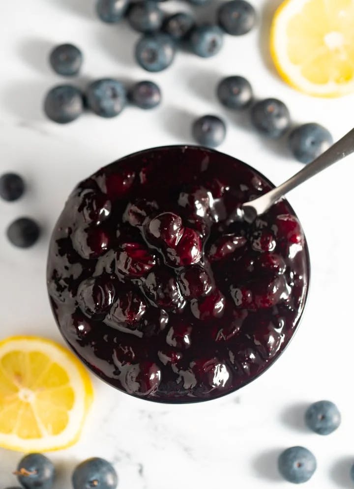 blueberry compote in bowl with spoon sticking out