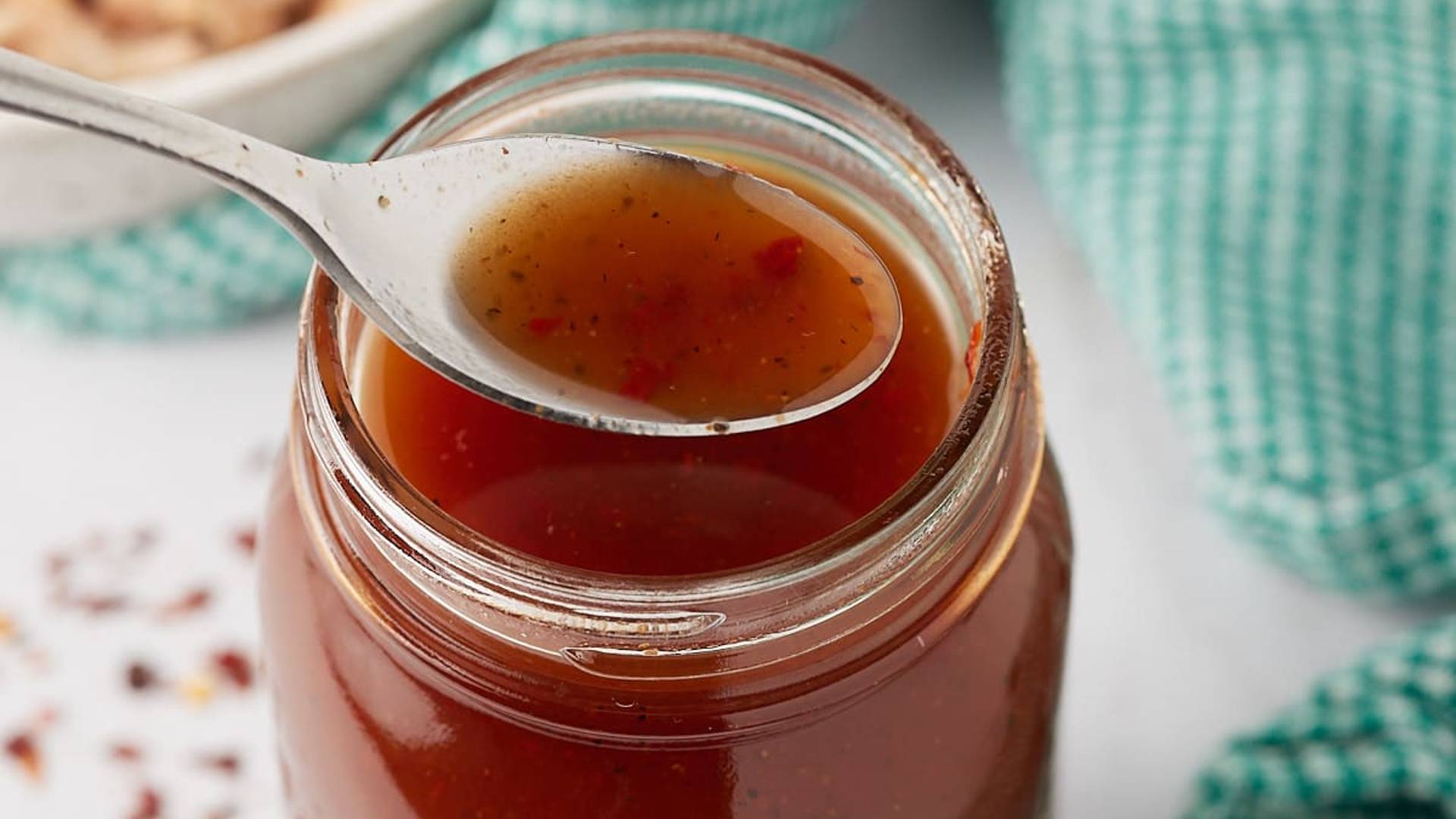 spoon picking up bbq sauce
