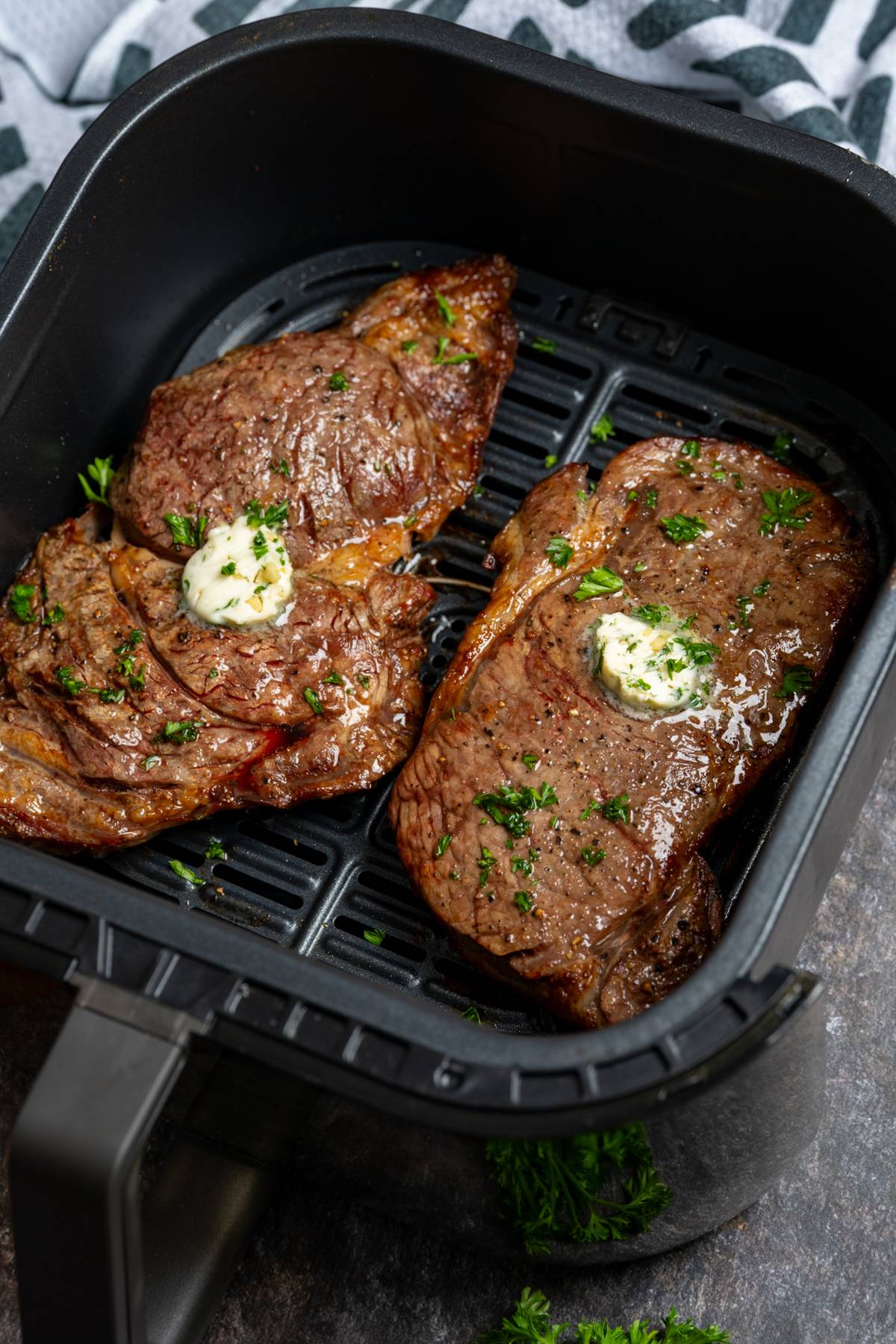 cooked steak in air fryer basket