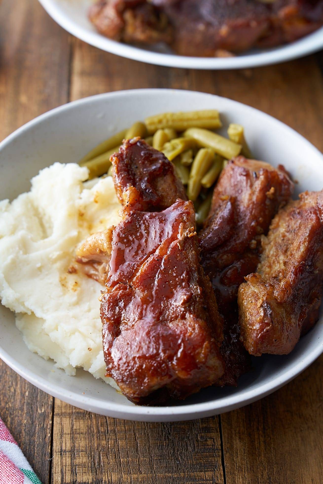 country style ribs on plate with green beans and mashed potatoes
