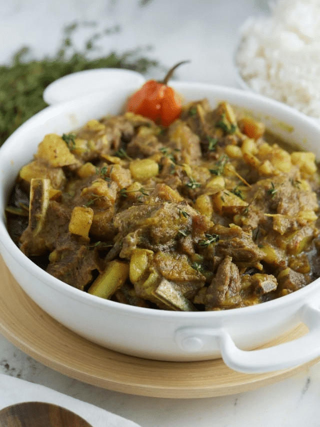 curry goat in white plate