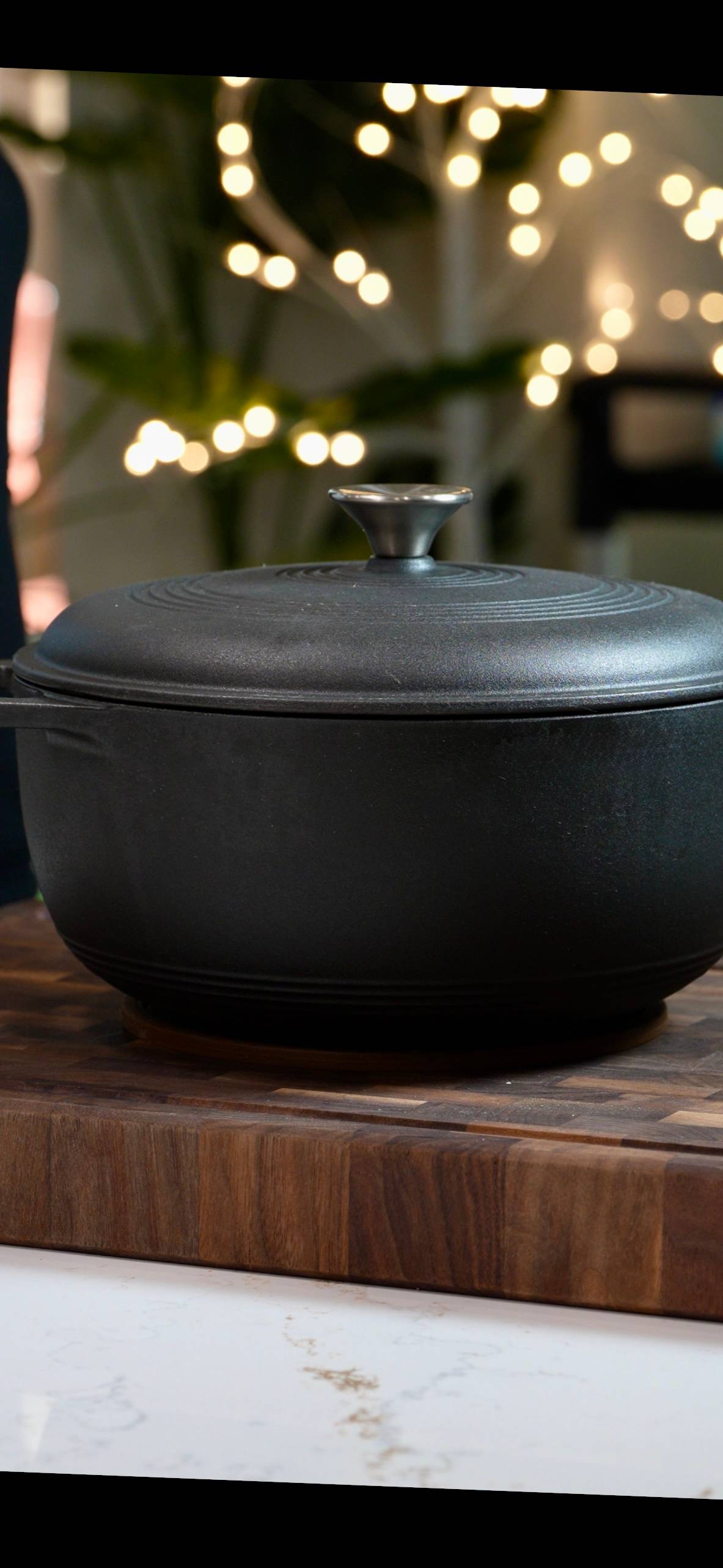 black dutch oven on cutting board