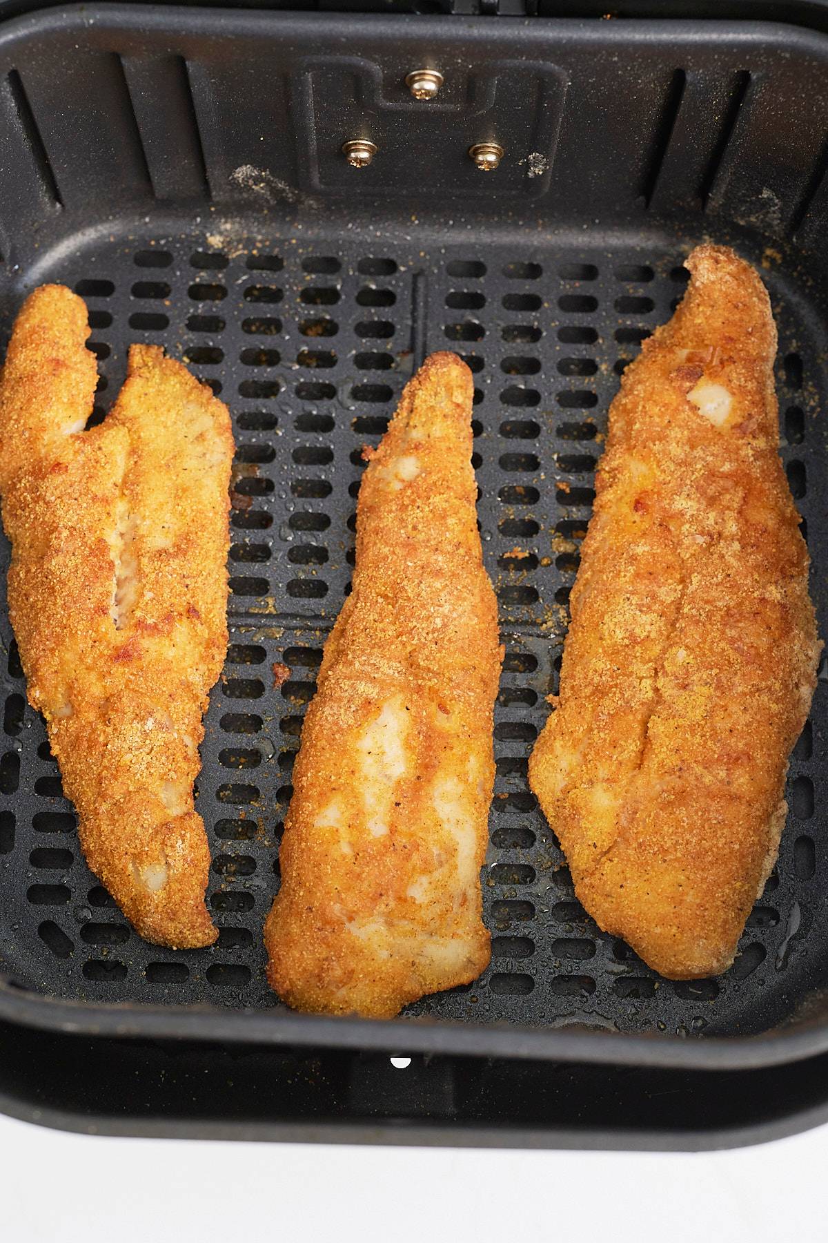 fried fish in air fryer basket