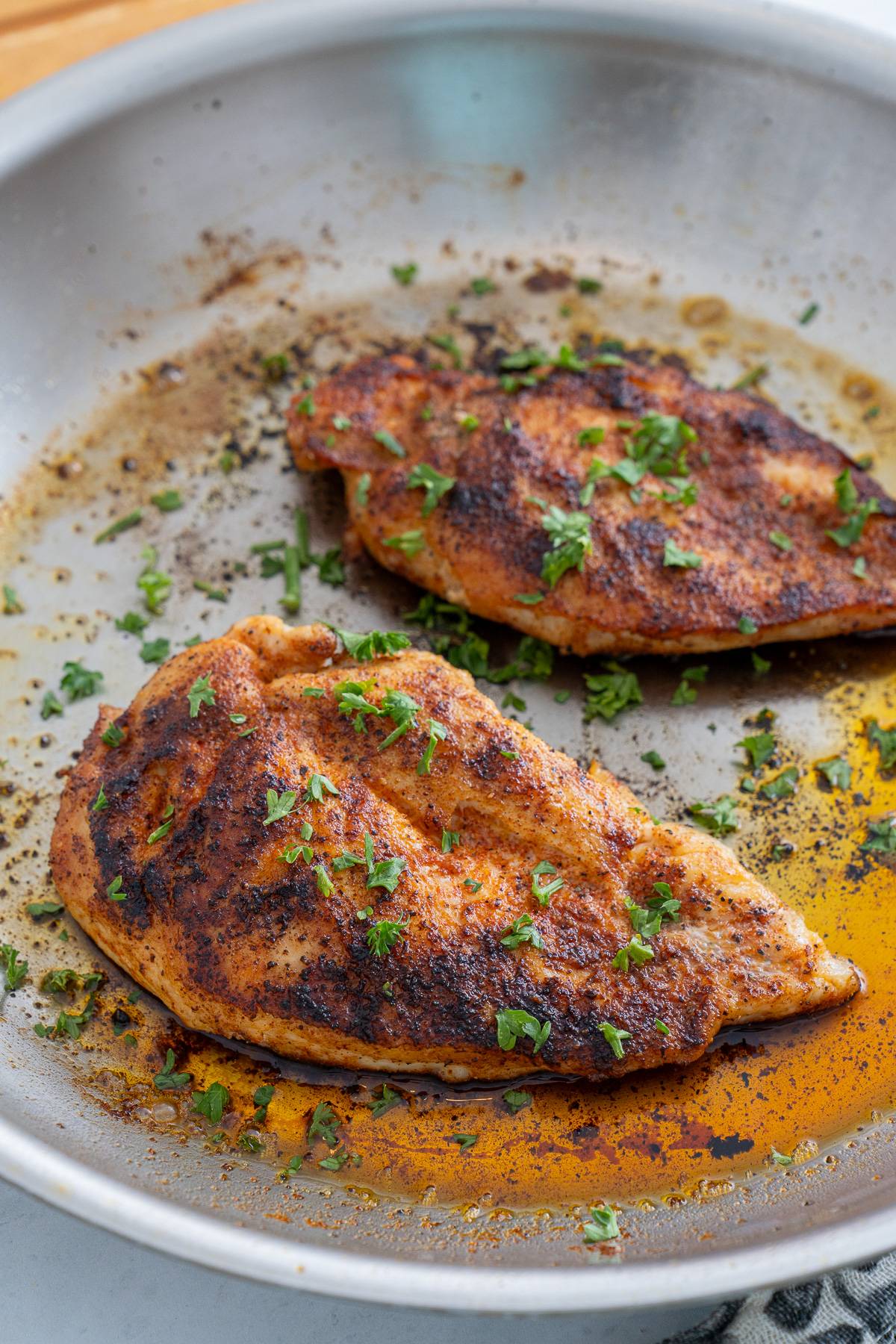 chicken breast in stainless steel skillet
