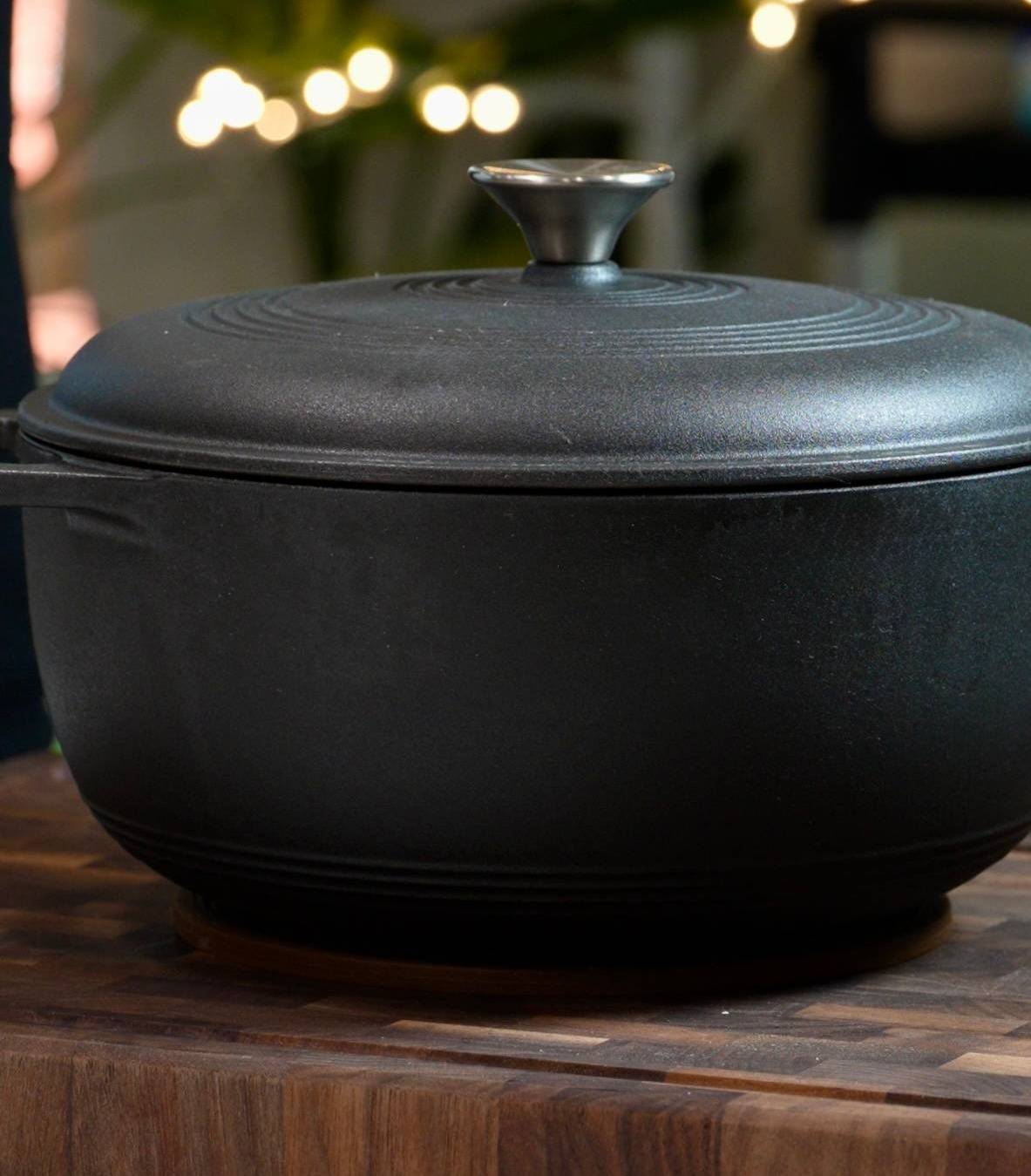 black dutch oven on cutting board
