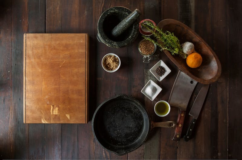 black mortar and pestle beside brown box in top view photography