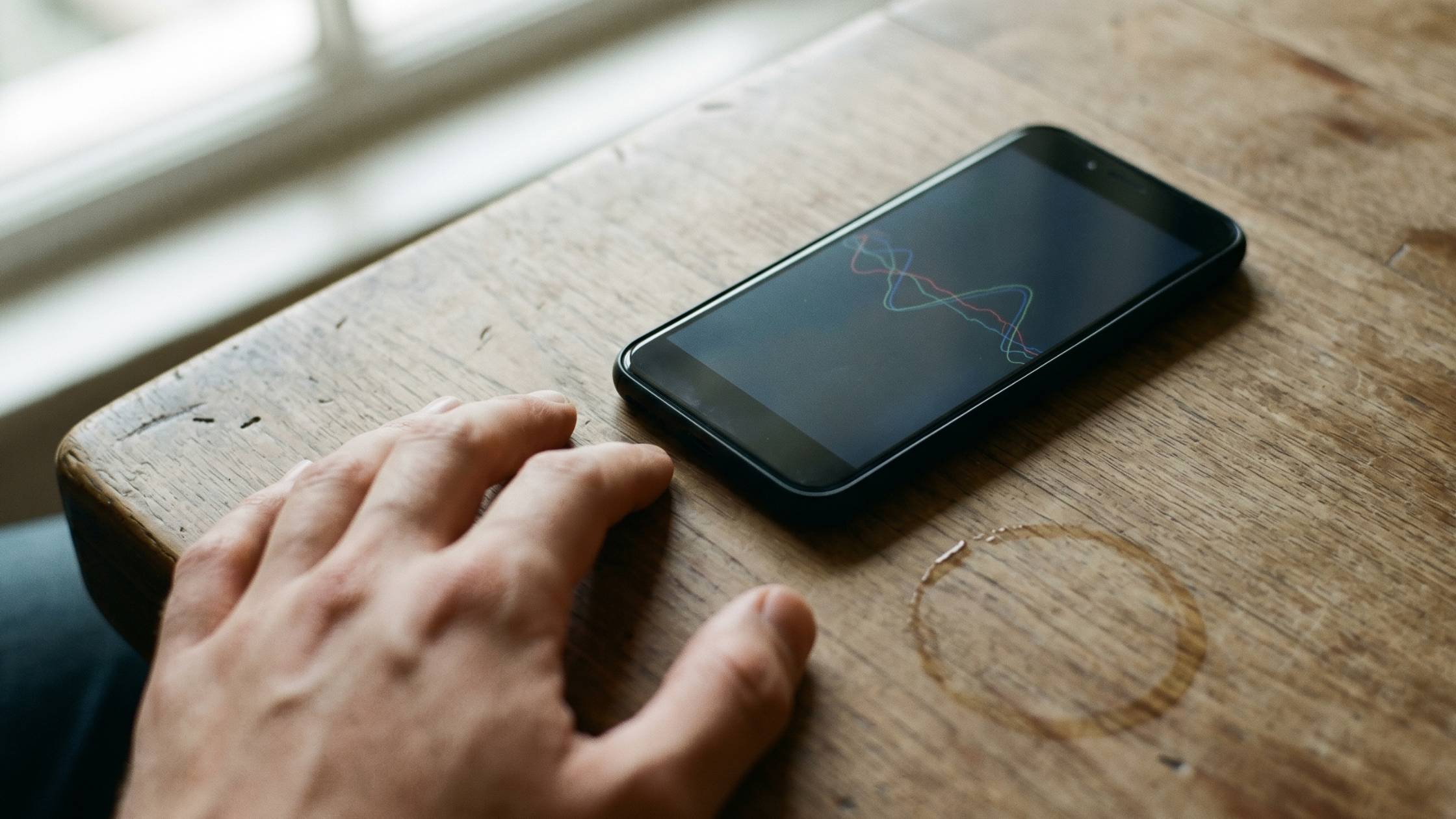 Smartphone on a wooden surface showing accelerometer motion trace data