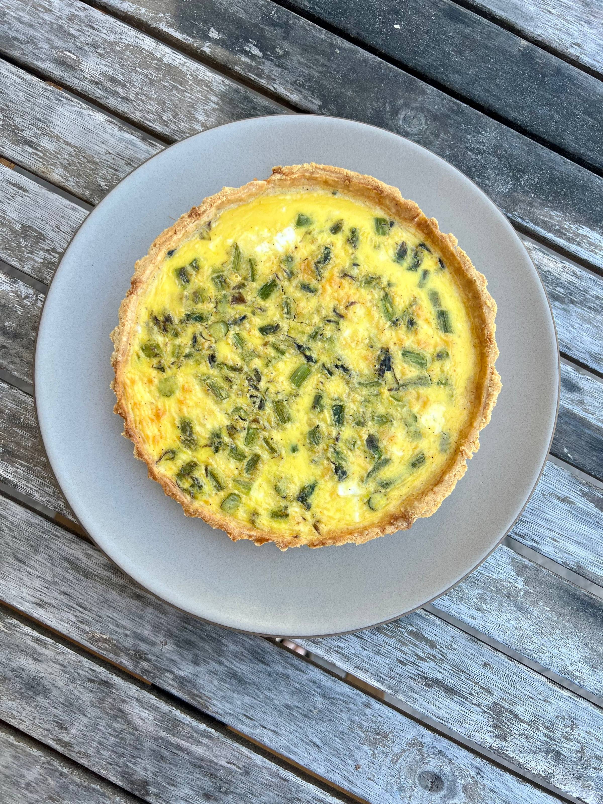 a close up of the asparagus and feta quiche