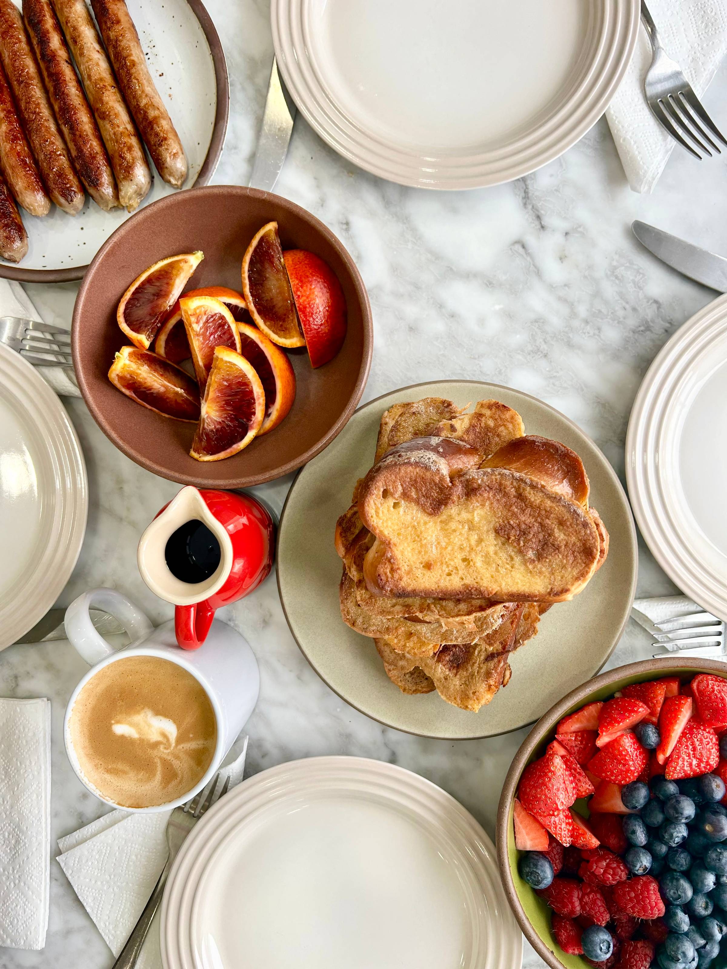 a plate of challah french toast and a breakfast spread