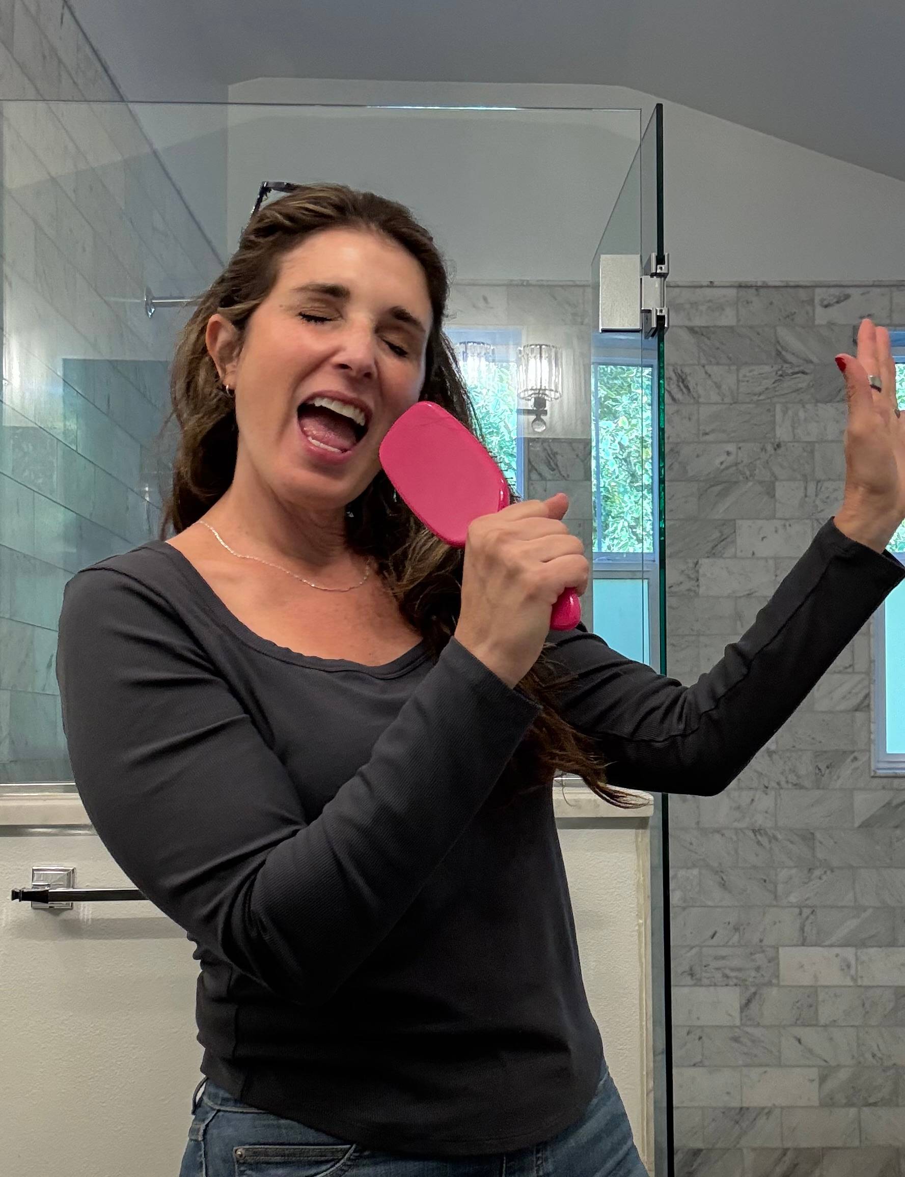 woman singing into her hairbrush