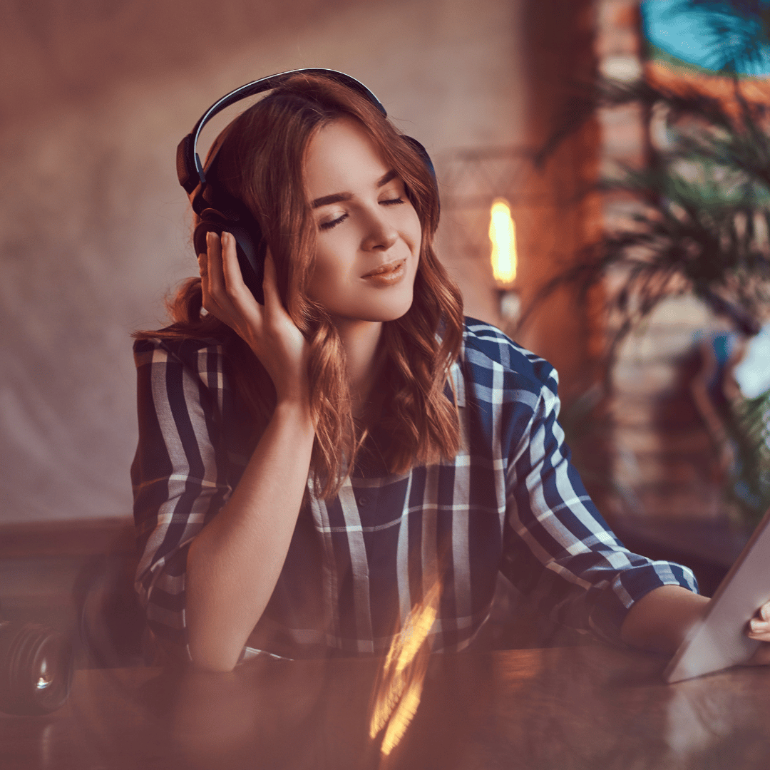 Woman with eyes closed listening to headphones
