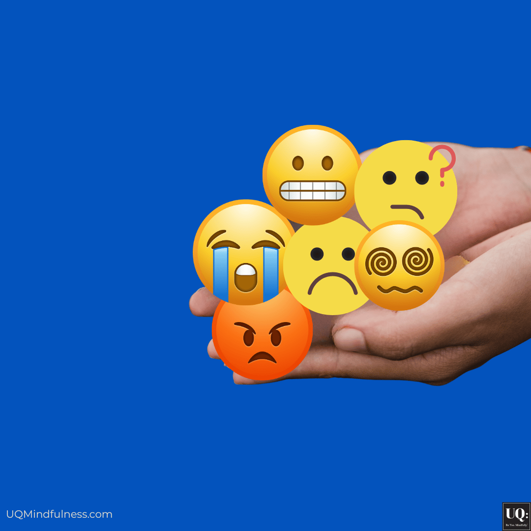 A hand holding emojis of difficult emotions: anxiety, frustration, overwhelm, sadness, and anger
