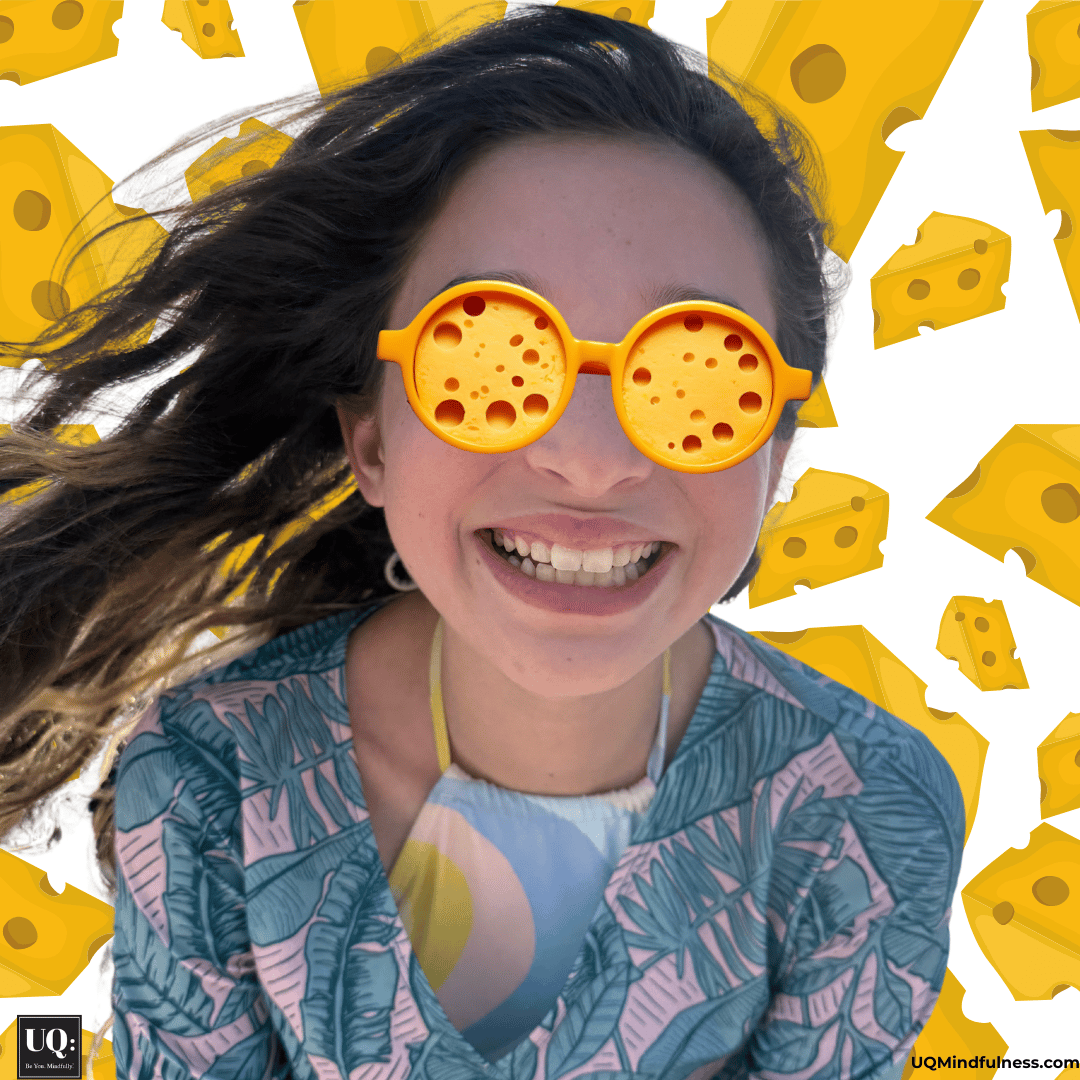 girl smiling with cheese glasses and a cheese background