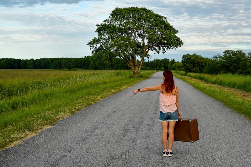 A woman hitchhiking 