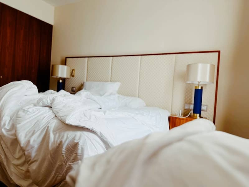 A bed with messy sheets after use.