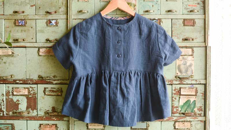 Cairo Linen Florence Top hanging on a hanger