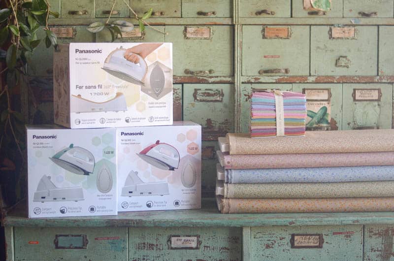 Panasonic irons and floral fabric stacked up. 