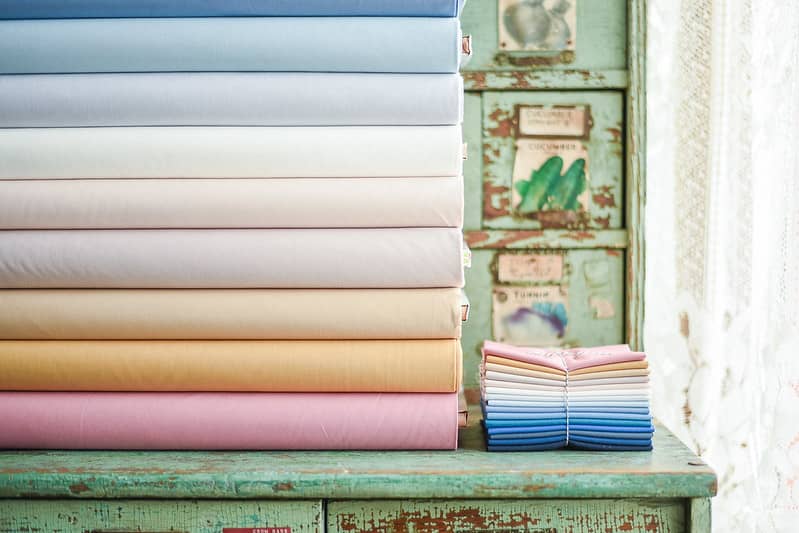 stack of kona solid cotton in blues and whites