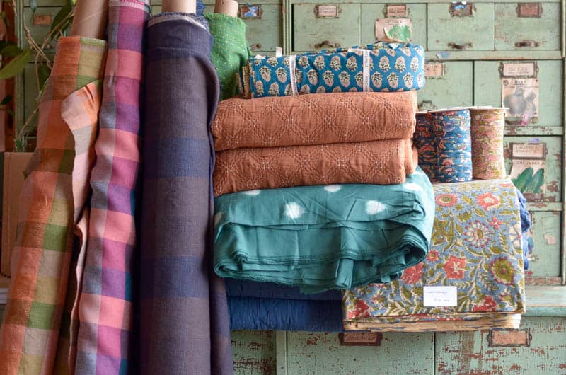 Merchant & Mills fabrics and trims piled up