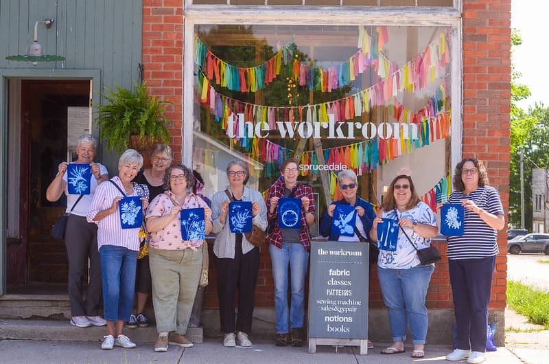 Group of women holding cyanotype fabric