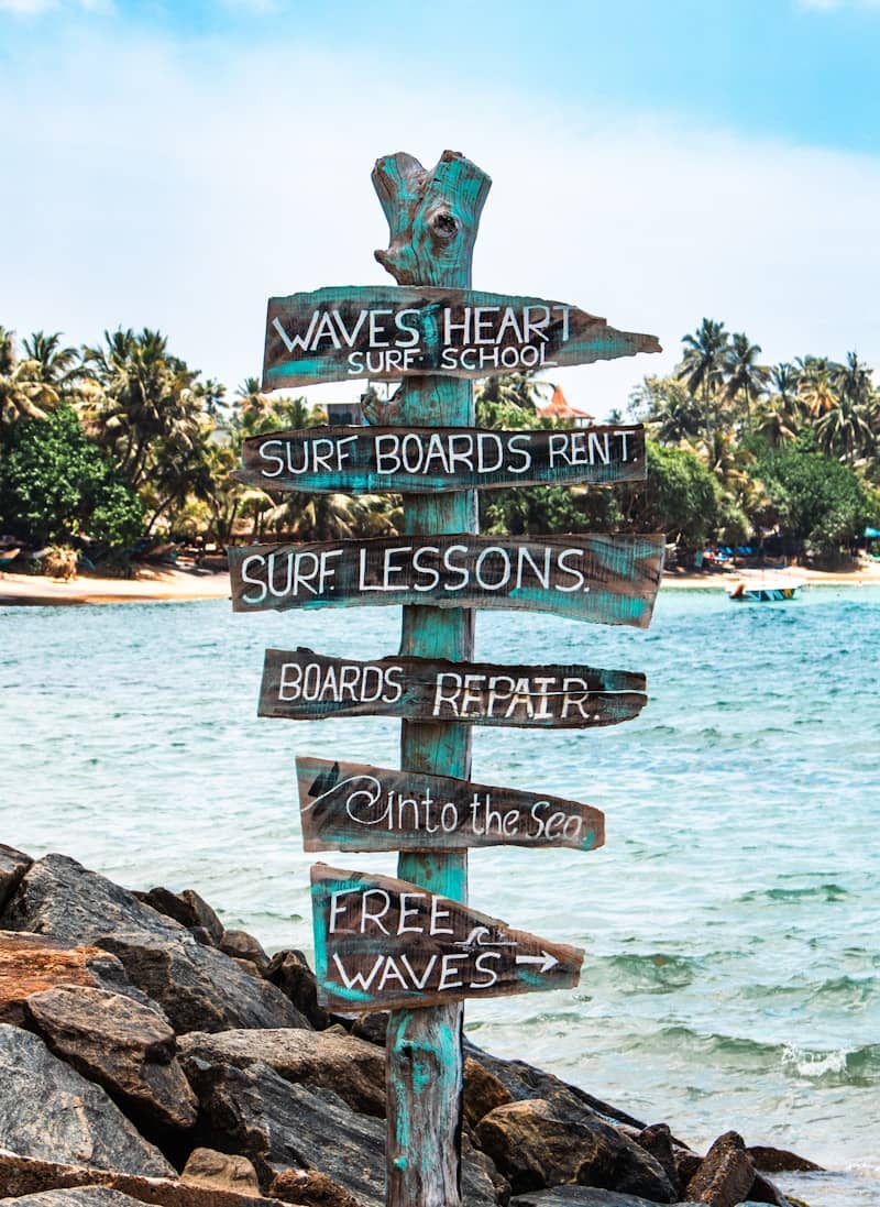 Sign points towards surf lessons and rentals.
