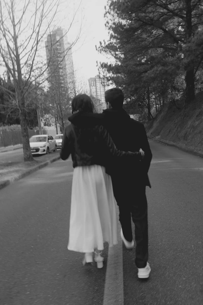 A couple strolls down a city street together.