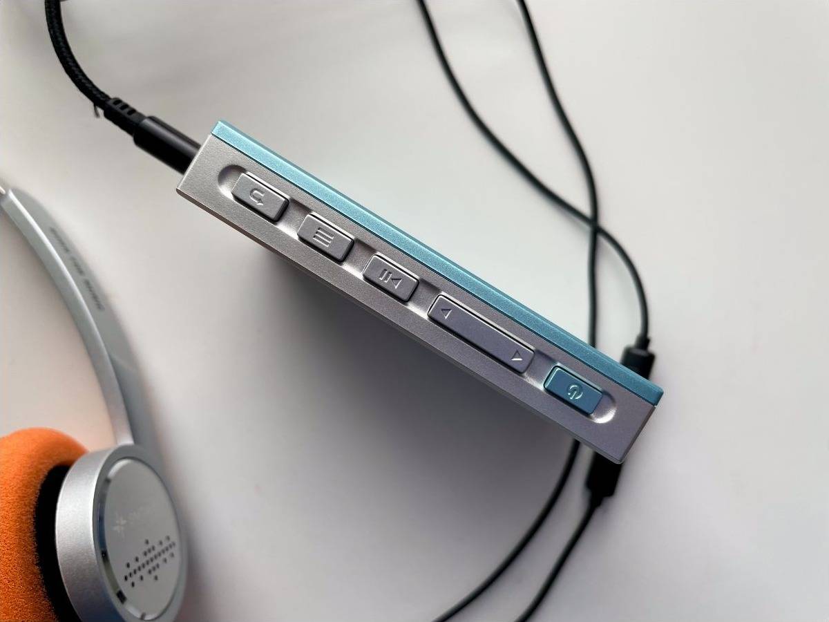 Close-up of the SNOWSKY Echo Mini’s side controls, including playback, menu, volume and power buttons.