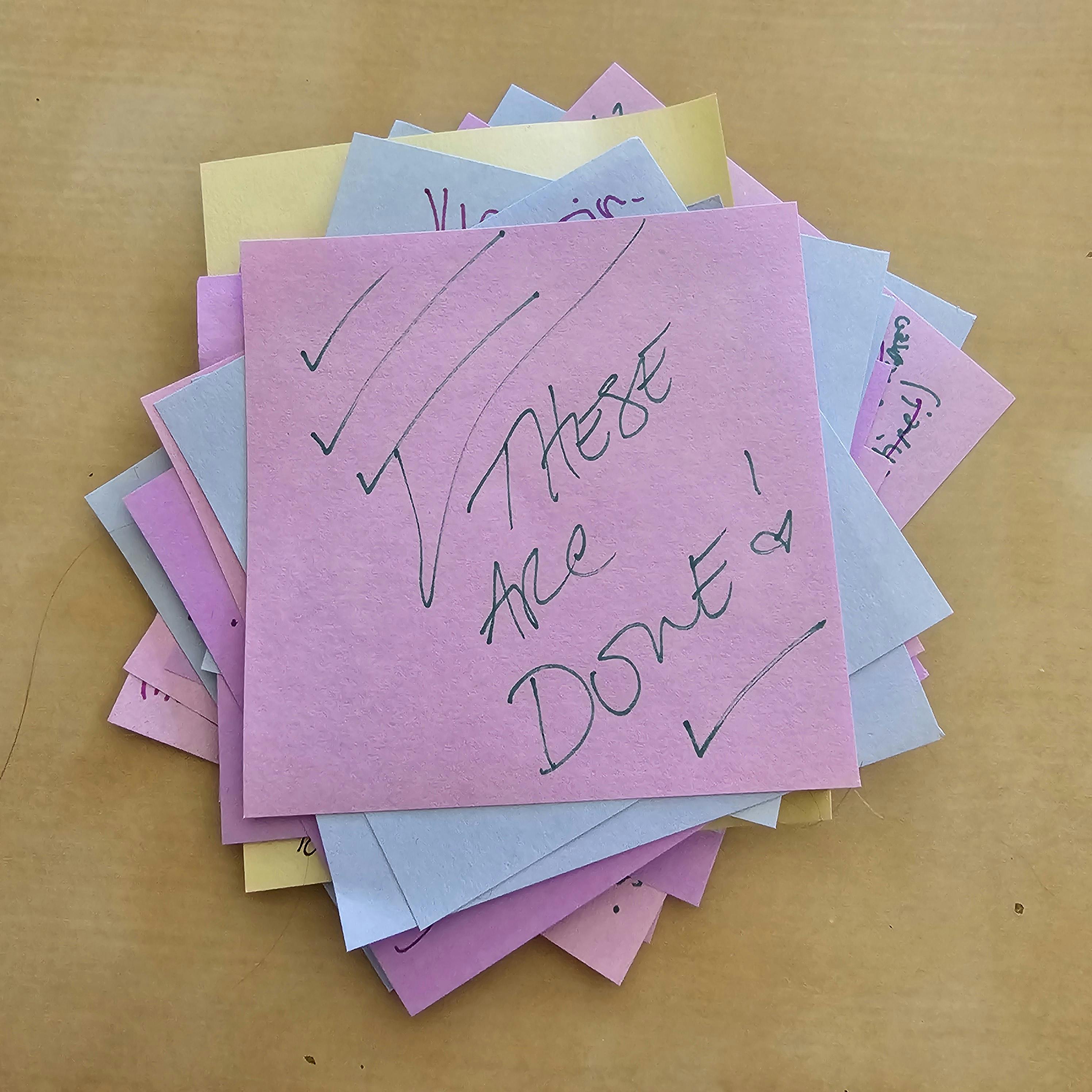 a stack of sticky notes with "DONE!" on top