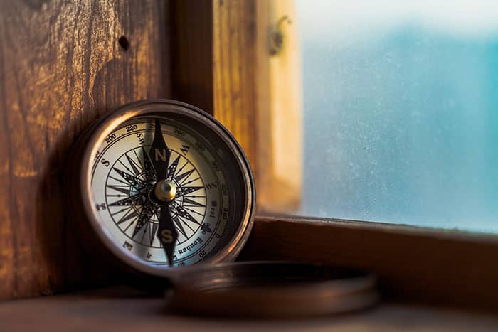 An open compass by a window