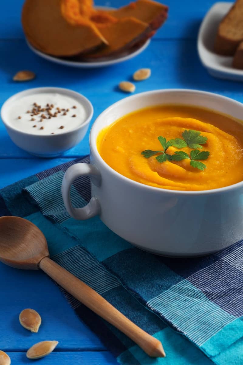 Creamy pumpkin soup with parsley and bread