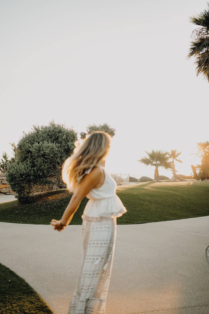 A woman riding a skateboard down a sidewalk