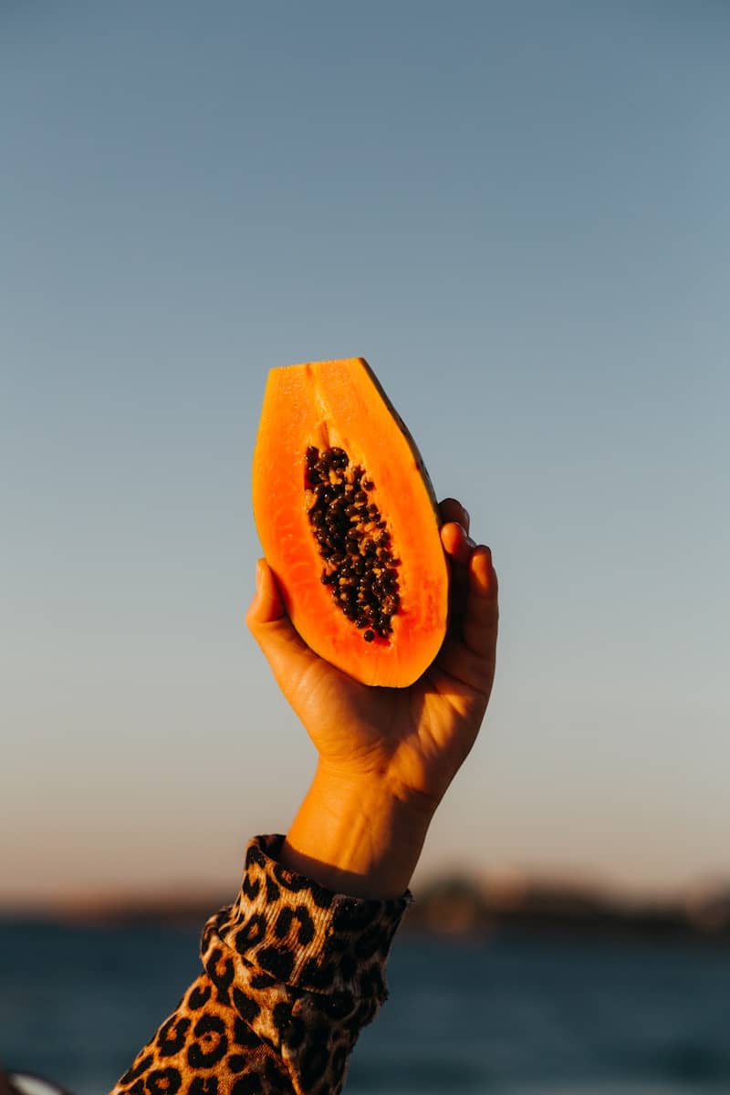person holding sliced watermelon fruit