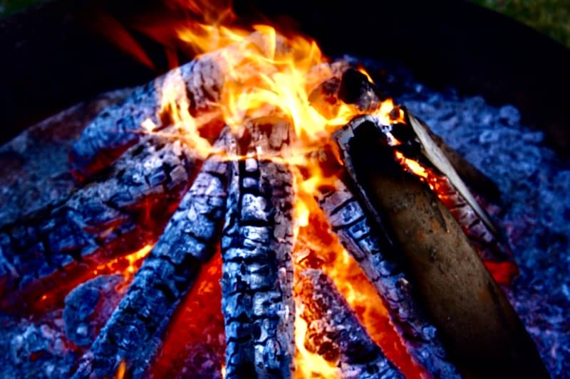 A campfire is burning with bright flames.