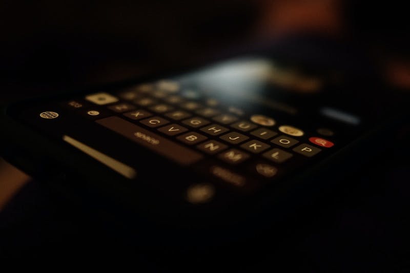 black qwerty phone turned on in dark room