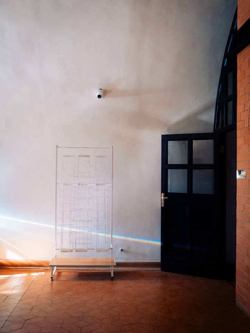 Open door with rainbow light on a white wall