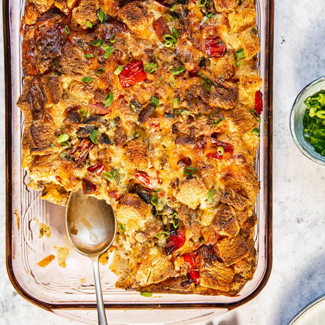 baking dish with egg casserole and a serving spoon