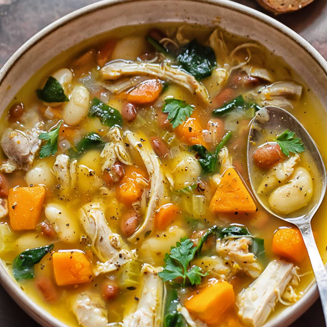 close up of a bowl of soup with chicken and vegetables