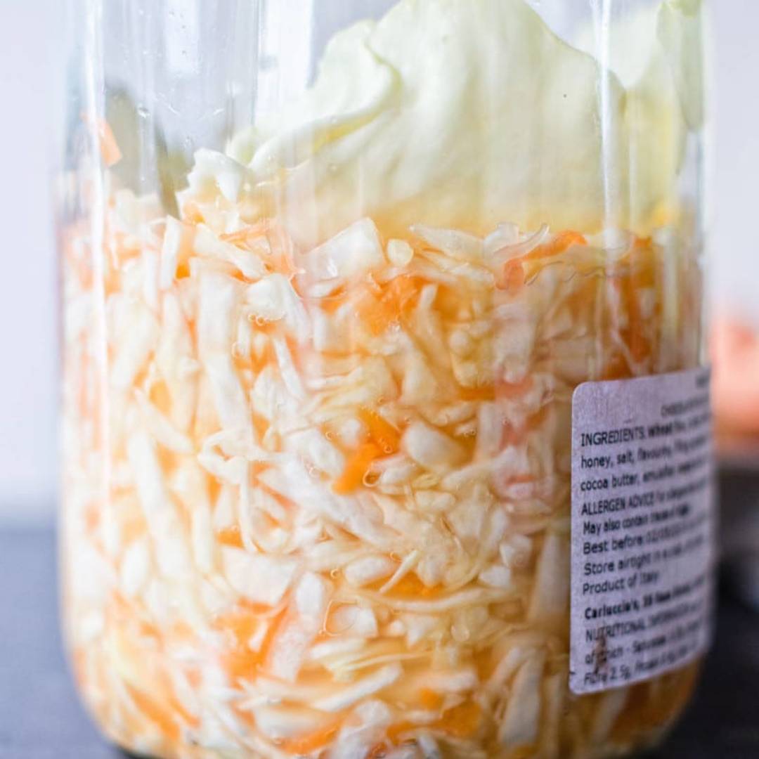 a jar half filled with cabbage and carrots