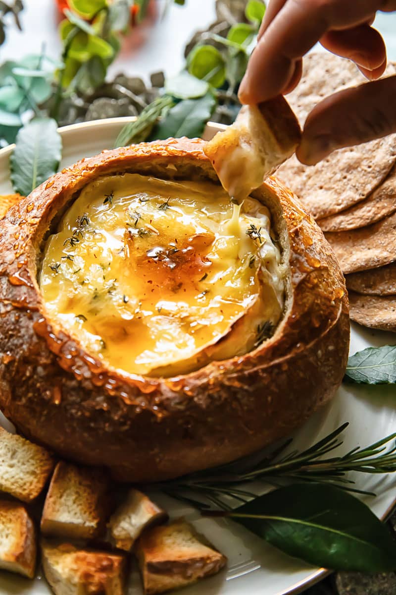 a bread bowl filled with a melty camembert 